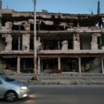 A damaged building in Homs, Syria, showing the scars of conflict.