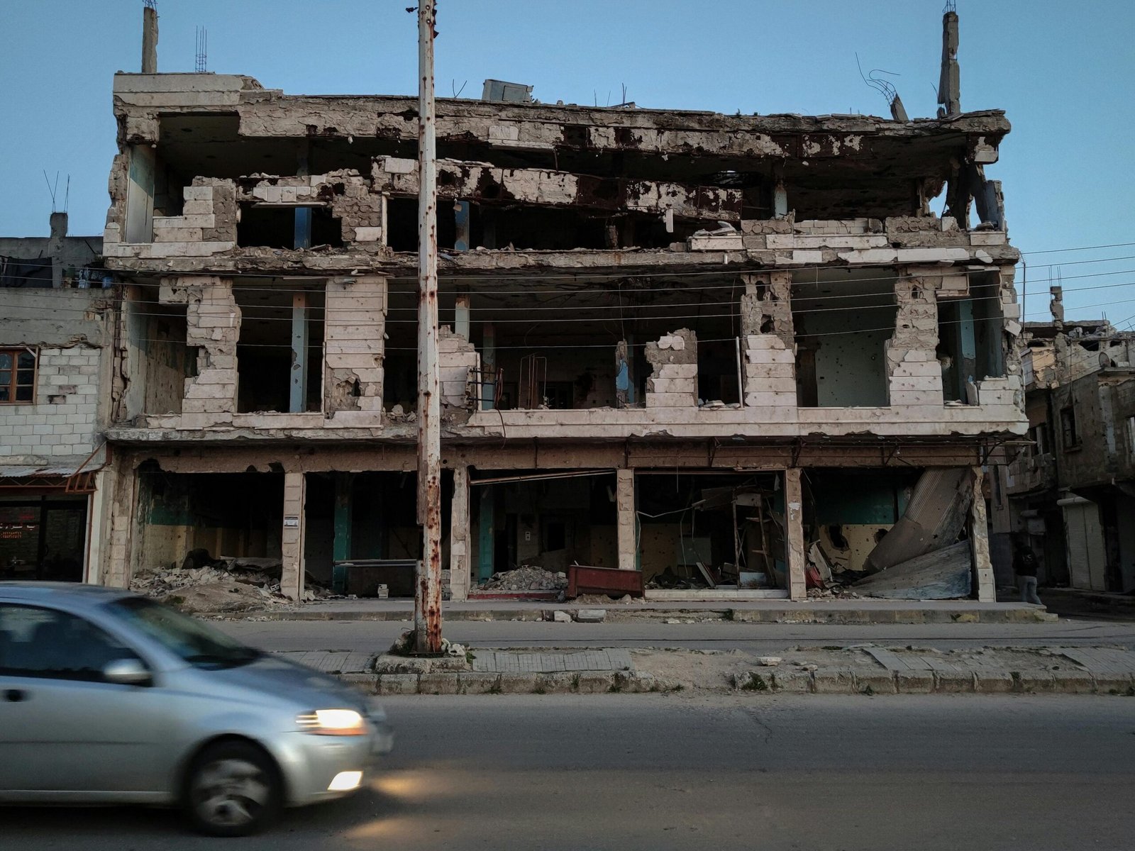 A damaged building in Homs, Syria, showing the scars of conflict.