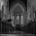 black and white photo of a church pew
